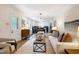 Cozy living room featuring a neutral sofa, wood accents, and an open layout to the eat-in kitchen at 1416 Bramble Dr, Durham, NC 27712