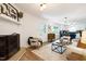 Cozy living room with fireplace, stylish furnishings, and a seamless transition to the kitchen and dining area at 1416 Bramble Dr, Durham, NC 27712