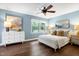 Serene main bedroom with blue walls, wood floors, and ample natural light from the window at 1416 Bramble Dr, Durham, NC 27712