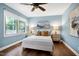 Comfortable main bedroom featuring a ceiling fan, plush bedding, and scenic views from the window at 1416 Bramble Dr, Durham, NC 27712