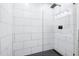 Sleek walk-in shower with modern tiling, a black shower head, and a glass enclosure at 1416 Bramble Dr, Durham, NC 27712