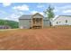 Rear view of the home with a grassy yard at 147 Harmony Trl, Broadway, NC 27505