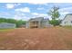 A view of the back yard, back of the home, and a detached garage at 147 Harmony Trl, Broadway, NC 27505
