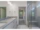 Bright bathroom boasts dual vanity, granite countertops, glass shower, and access to bedroom at 147 Harmony Trl, Broadway, NC 27505