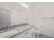 A pristine bathroom with a double sink vanity featuring granite countertops and white cabinets at 147 Harmony Trl, Broadway, NC 27505