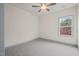 An inviting bedroom with soft carpet, a ceiling fan, and a window providing natural light at 147 Harmony Trl, Broadway, NC 27505