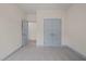 A light-filled bedroom with neutral carpet and trim with connecting doors at 147 Harmony Trl, Broadway, NC 27505