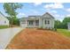 Charming single-Gathering home with covered porch, attached garage, and newly seeded front yard at 147 Harmony Trl, Broadway, NC 27505
