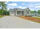 Exterior of the home with a driveway, 2-car garage, and nice landscaping at 147 Harmony Trl, Broadway, NC 27505