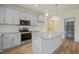 Well-lit kitchen features stainless steel appliances, center island, and subway tile backsplash at 147 Harmony Trl, Broadway, NC 27505