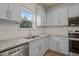 Bright kitchen showcases gray cabinets, stainless steel appliances, and granite countertops at 147 Harmony Trl, Broadway, NC 27505