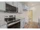 Kitchen features stainless steel appliances, gray cabinets, granite countertops, and tiled backsplash at 147 Harmony Trl, Broadway, NC 27505