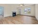 Beautiful living room with a fireplace, ceiling fan, hardwood floors, and natural light at 147 Harmony Trl, Broadway, NC 27505
