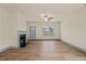 Bright living room featuring a fireplace, ceiling fan, a large window, and wood flooring at 147 Harmony Trl, Broadway, NC 27505