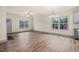 Open concept living room and dining area with modern chandelier and large windows at 147 Harmony Trl, Broadway, NC 27505