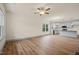Open-concept space featuring hardwood floors and large windows, with view into kitchen at 147 Harmony Trl, Broadway, NC 27505