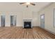 Spacious living room with fireplace, ceiling fan, and luxury vinyl plank flooring at 147 Harmony Trl, Broadway, NC 27505
