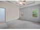 Spacious bedroom with tray ceiling, carpeted flooring, and decorative wall accent at 147 Harmony Trl, Broadway, NC 27505