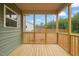 Enclosed back porch with wooden decking overlooking a yard at 147 Harmony Trl, Broadway, NC 27505