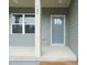 Close up of the covered front porch showcasing the front door, number and window at 147 Harmony Trl, Broadway, NC 27505