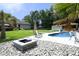 Enjoy this backyard featuring an in-ground pool, well-manicured lawn, and an outdoor fire pit for your enjoyment at 150 Churchill Rd, Louisburg, NC 27549