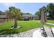 This backyard has a lush lawn and an outdoor dining area that provides an ideal space for relaxing or entertaining at 150 Churchill Rd, Louisburg, NC 27549