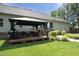 A backyard scene with a wooden patio covered by a gazebo and a lawn at 150 Churchill Rd, Louisburg, NC 27549