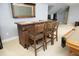 Stylish bar area with wood bar, mirror, and seating for entertaining guests at 150 Churchill Rd, Louisburg, NC 27549