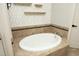Close up of the bathtub in the bathroom featuring decorative accent tiles at 150 Churchill Rd, Louisburg, NC 27549