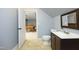 En Suite bathroom featuring dark vanity, toilet, and access to game room at 150 Churchill Rd, Louisburg, NC 27549