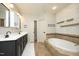 Beautiful bathroom featuring double sinks, a soaking tub, and designer tile accents at 150 Churchill Rd, Louisburg, NC 27549