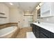 Beautiful bathroom featuring double sinks, a soaking tub, and shower at 150 Churchill Rd, Louisburg, NC 27549