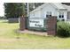 Neighborhood sign with beautiful landscaping and manicured lawn at 150 Churchill Rd, Louisburg, NC 27549