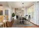Virtually staged dining area with hardwood floors, stylish lighting, and dining set with seating for four at 150 Churchill Rd, Louisburg, NC 27549