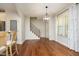 Bright dining area with hardwood floors, stylish lighting, and easy access to the kitchen and staircase at 150 Churchill Rd, Louisburg, NC 27549