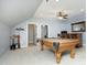 Open game room with pool table, bar area, and neutral color palette at 150 Churchill Rd, Louisburg, NC 27549