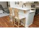Kitchen with seating, quartz countertops, stainless steel appliances and hardwood flooring at 150 Churchill Rd, Louisburg, NC 27549