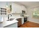Bright kitchen featuring white cabinets, stainless steel appliances, and stylish lighting fixtures at 150 Churchill Rd, Louisburg, NC 27549