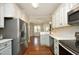 Well-equipped kitchen with stainless steel appliances, ample counter space, and an open view to the dining area at 150 Churchill Rd, Louisburg, NC 27549