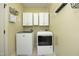 Functional laundry room equipped with washer, dryer, and ample storage space at 150 Churchill Rd, Louisburg, NC 27549
