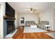Comfortable living room with a fireplace, ceiling fan, hardwood floors, and neutral decor at 150 Churchill Rd, Louisburg, NC 27549