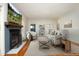 Staged living room with a fireplace, hardwood floors, and comfortable seating arrangement at 150 Churchill Rd, Louisburg, NC 27549