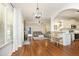 Open-concept living space featuring hardwood floors, abundant natural light, and seamless flow to the kitchen at 150 Churchill Rd, Louisburg, NC 27549