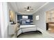 Cozy primary bedroom with tray ceiling, neutral carpet, ensuite bathroom access, and tastefully decorated at 150 Churchill Rd, Louisburg, NC 27549