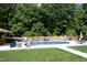 The backyard has an in-ground pool with ample room for chairs, with a lawn and privacy fence creating a tranquil retreat at 150 Churchill Rd, Louisburg, NC 27549