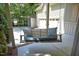 Relaxing porch swing with decorative pillows on a covered porch at 150 Churchill Rd, Louisburg, NC 27549
