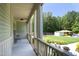 The view of the covered porch from the backyard provides a relaxing spot to unwind, with a view of the expansive property at 150 Churchill Rd, Louisburg, NC 27549