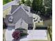 Birds-eye view of the home's backyard, showcasing patio with outdoor kitchen, fireplace, and landscaping at 1512 Obrien Cir, Wake Forest, NC 27587