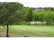 Beautiful golf course backyard with a large, well-maintained green, surrounded by mature trees and a pond at 1512 Obrien Cir, Wake Forest, NC 27587