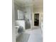 Beautiful bathroom featuring a glass-enclosed shower, soaking tub, and luxurious tile flooring at 1512 Obrien Cir, Wake Forest, NC 27587